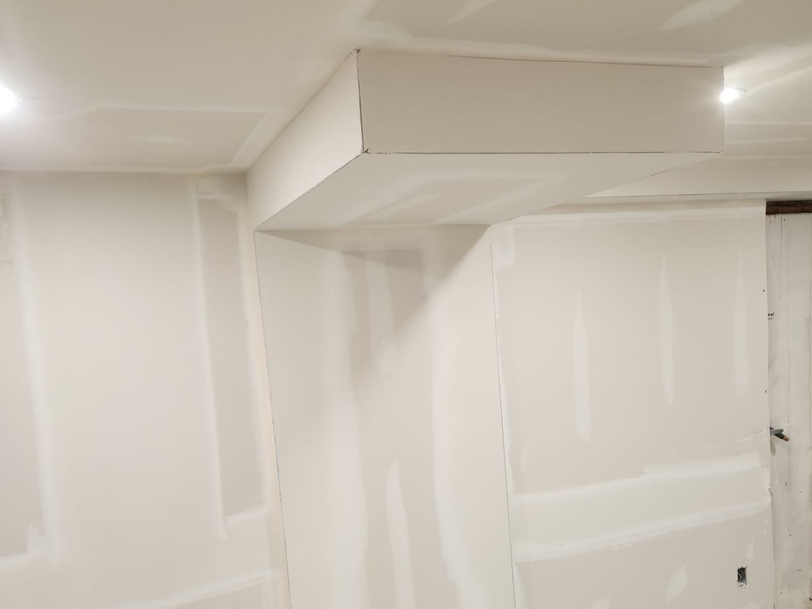 Basement bulkhead and walls with taped and mudded seams and screw holes