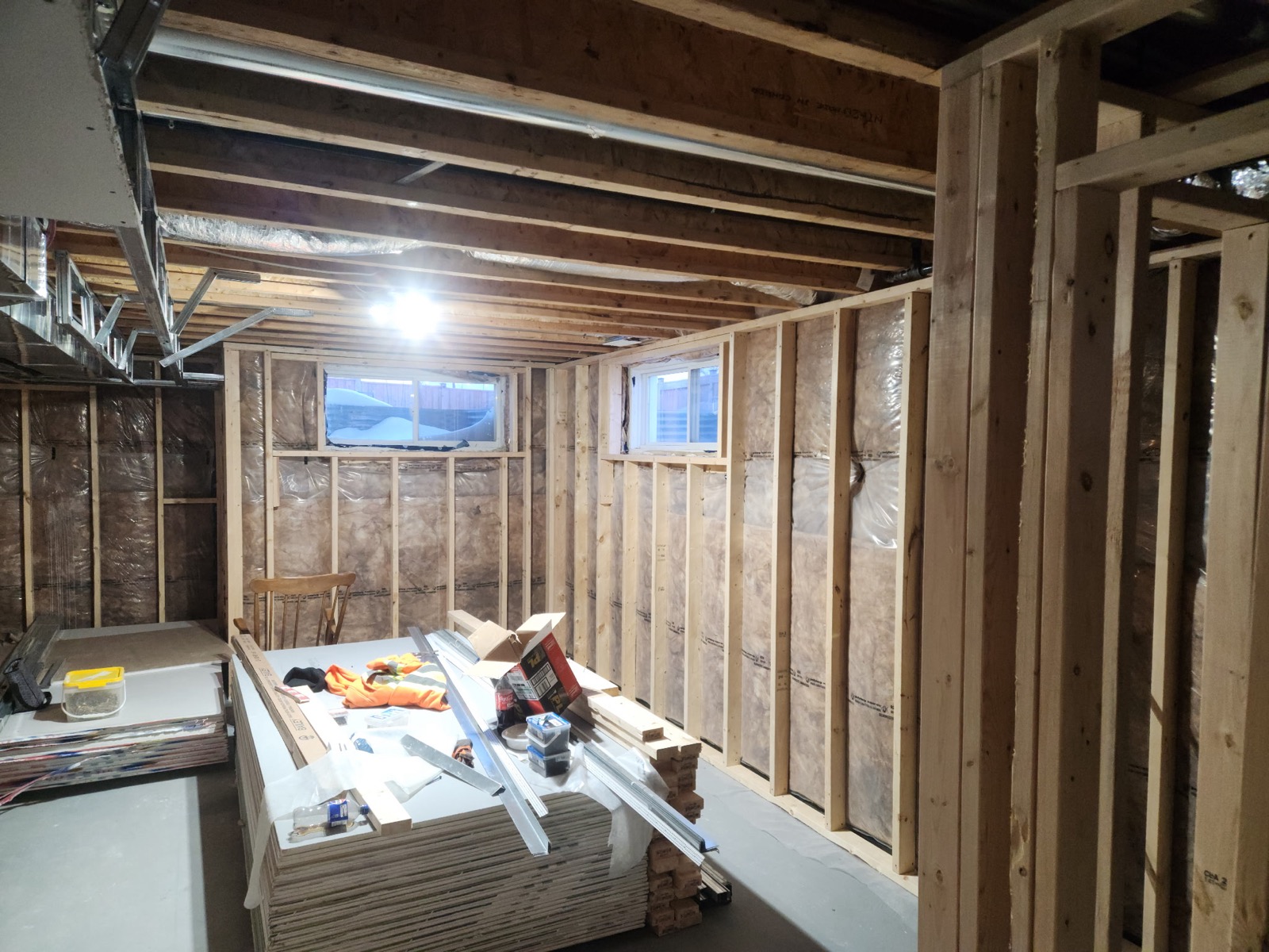 Framed basement room with insulated walls and drywall staged for boarding